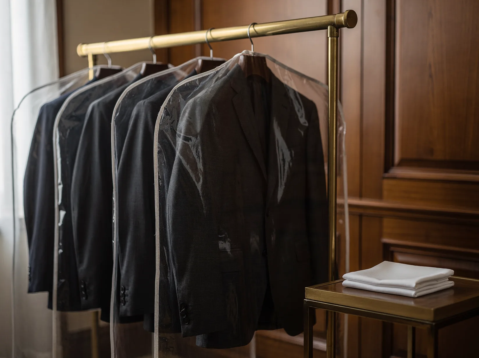 Pressed suits in garment covers for a funeral home account