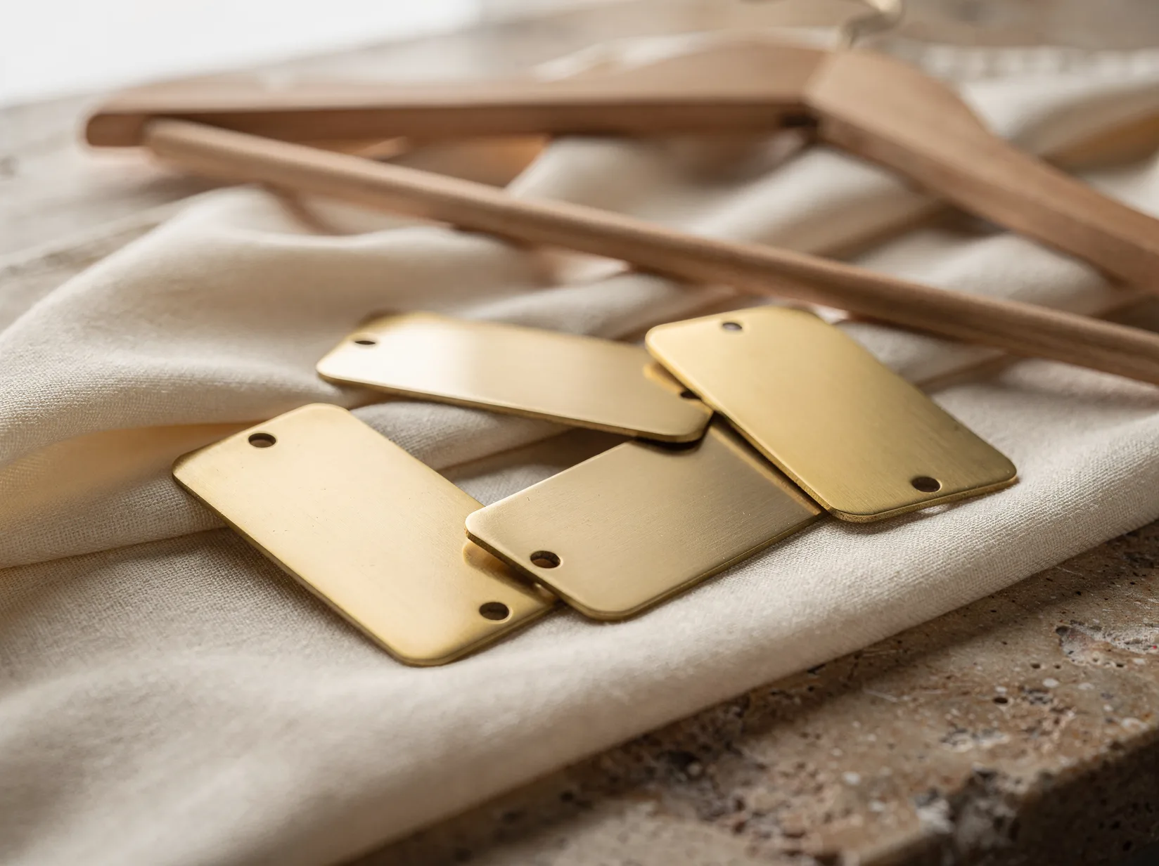 Brass garment tags on folded linen